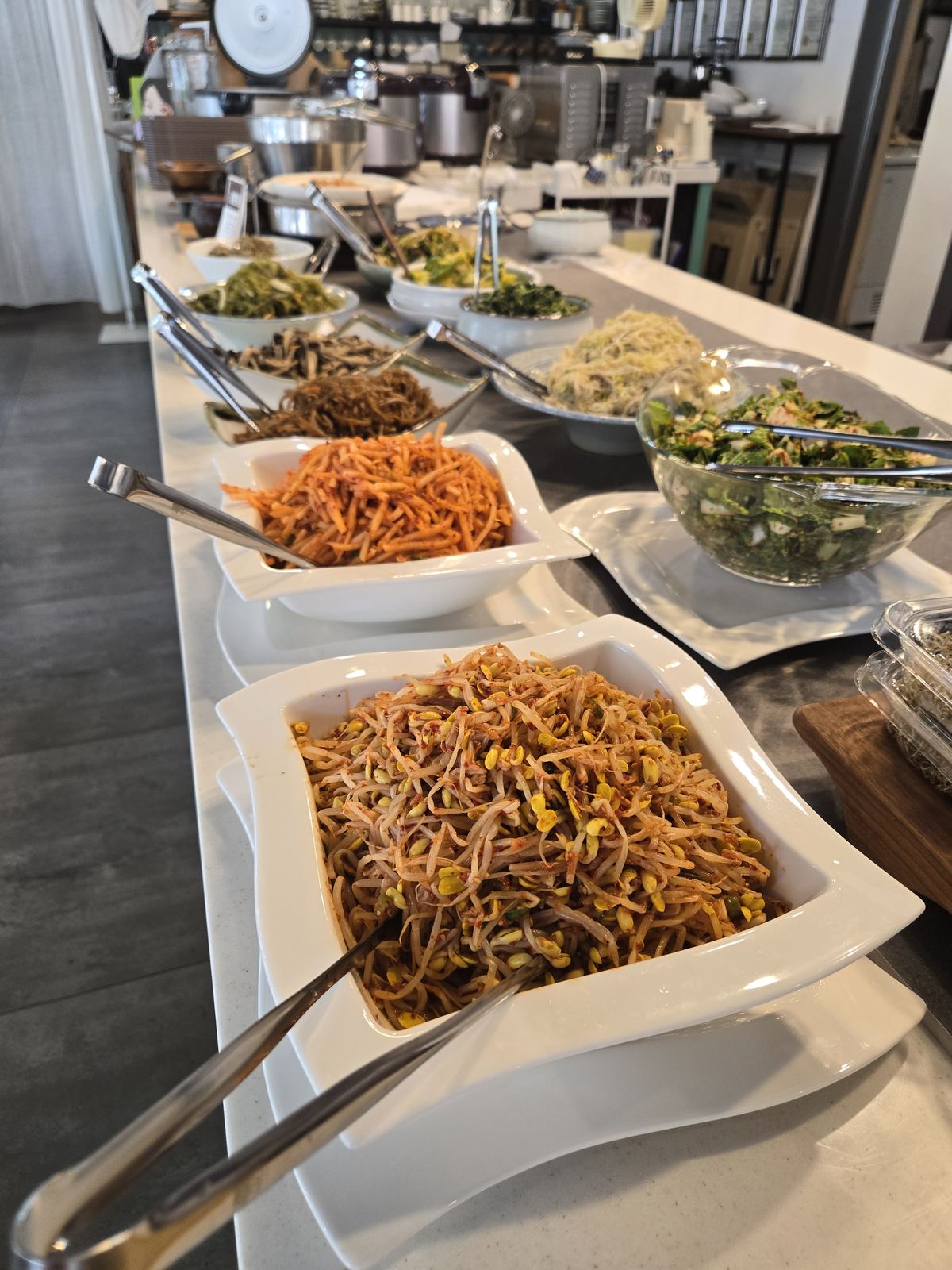 Seasoned vegetable side dishes on the buffet line