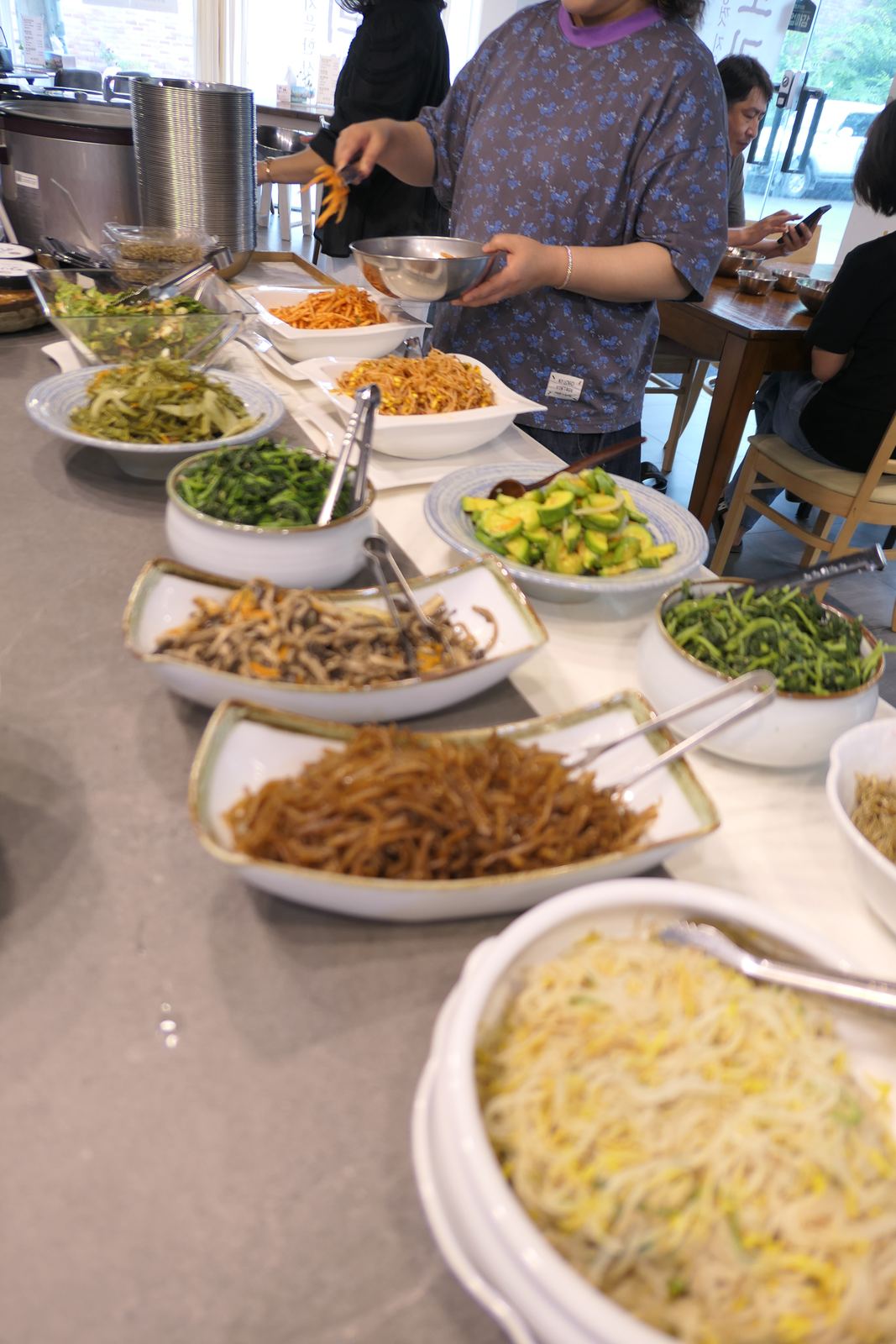 Guests serving themselves at the barley rice buffet