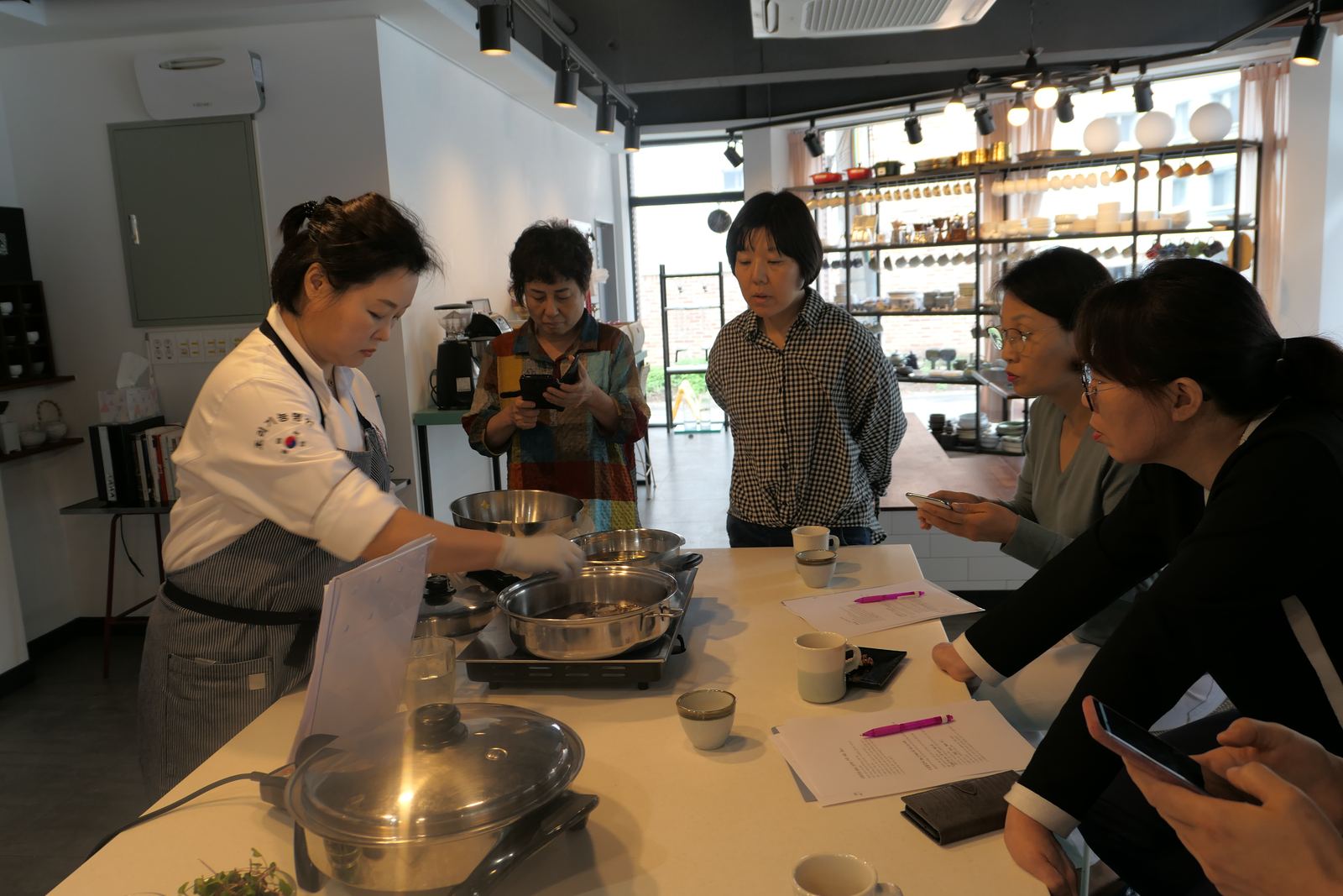 Jang Young-Hea demonstrating cooking technique to students at her studio