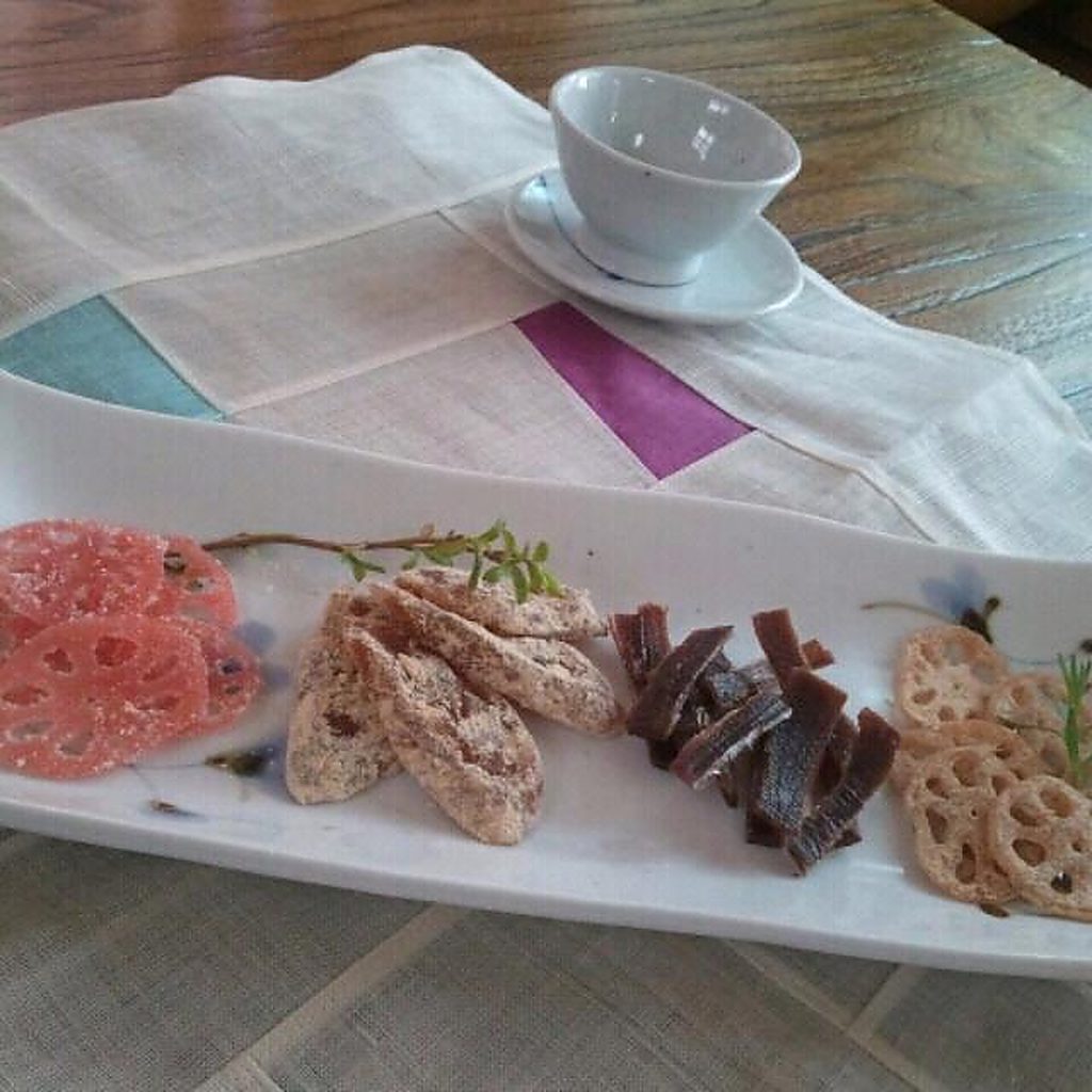 Traditional tea setting with sweets on a linen runner