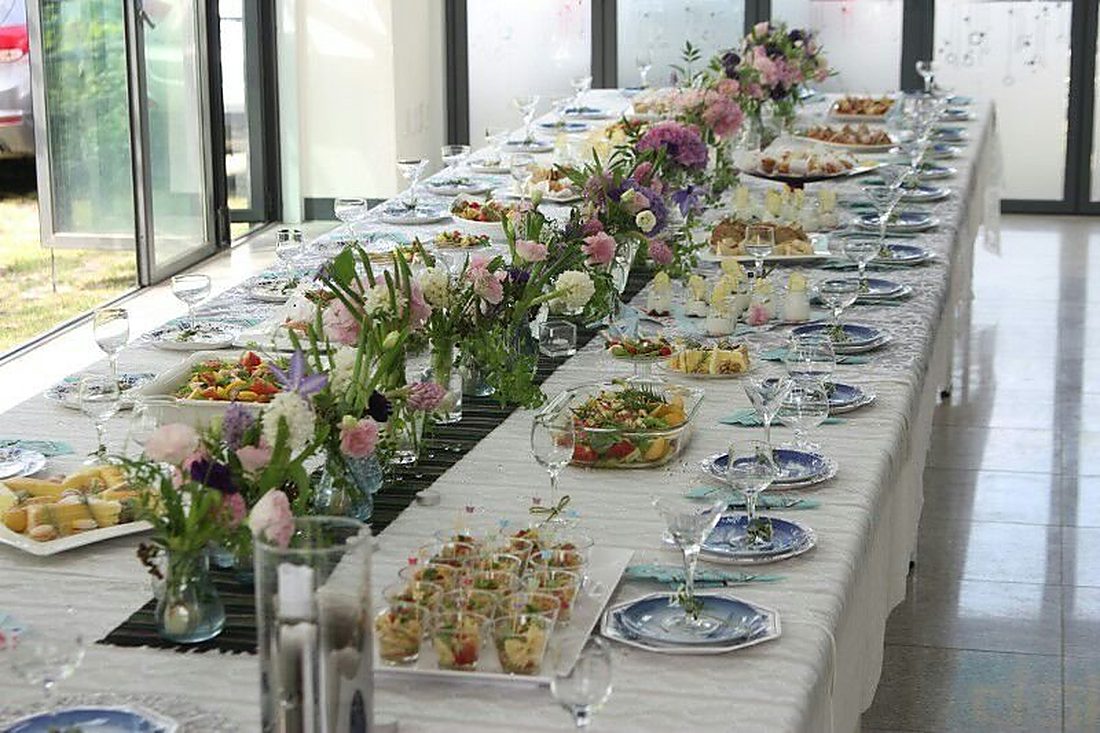 Long banquet table set with canapés and flowers