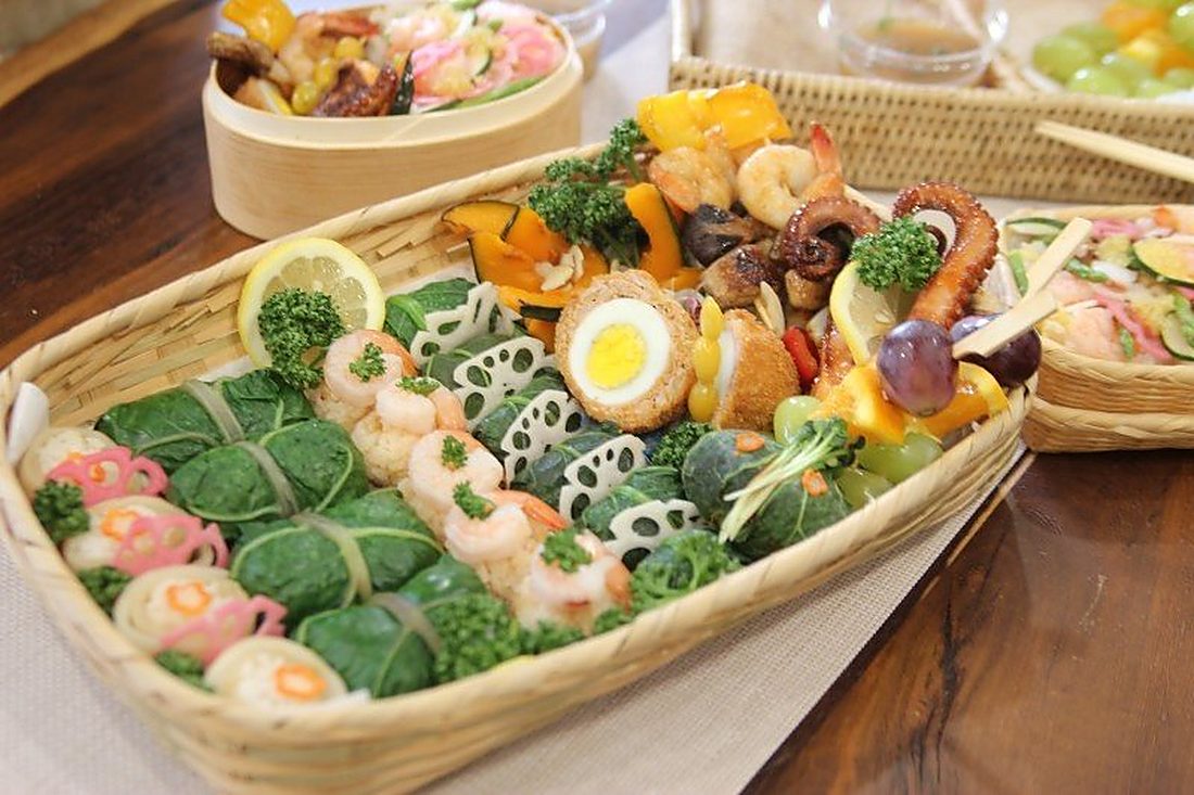Bamboo basket platter of assorted prepared dishes