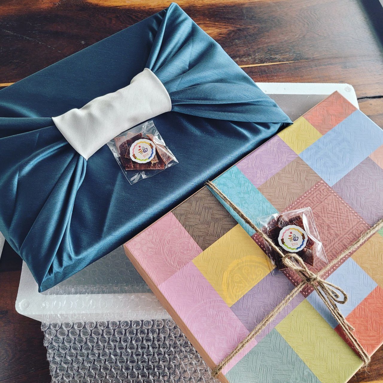 Gift set wrapped in teal silk bojagi with patchwork cloth
