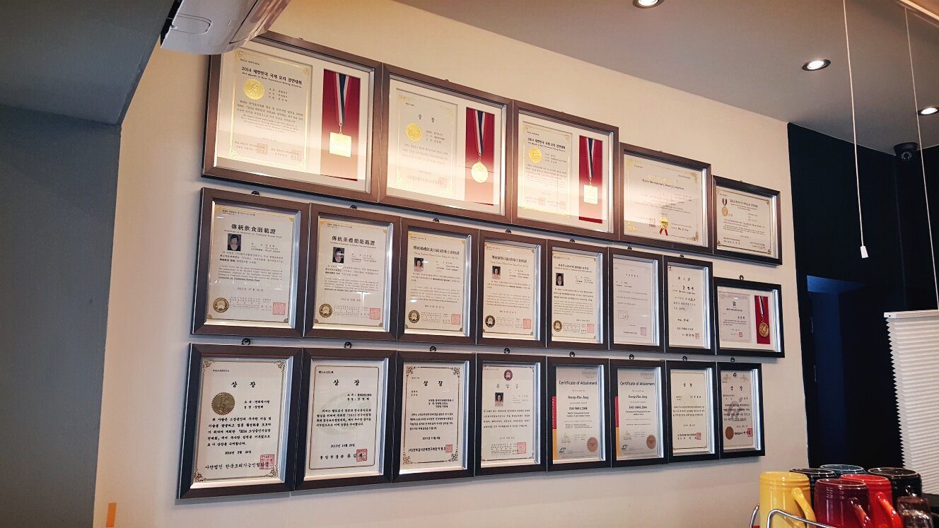 Wall of certifications and awards at Cooking Studio Jang